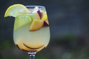 Limoncello sangria, a wine-based drink, is a light and lemony alternative to the traditional brunch mimosa. It consists of sugar, water, limoncello, white wine, club soda and chopped fruit.