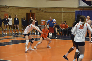 Two Syracuse players near each other to hit the ball. SU had 64 digs to BC's 62.