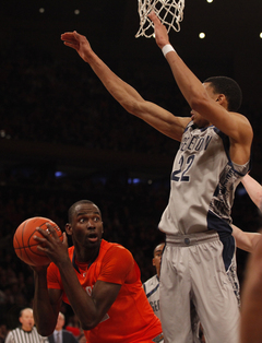 Baye Moussa Keita (#12) fights his way in the paint around Georgetown's Otto Porter (#22) after catching a rebound.