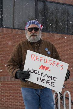 A protester holds a sign that reads, 