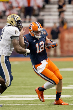 Syracuse quarterback Ryan Nassib eludes Pittsburgh linebacker Todd Thomas during the Orange's game against Pittsburgh. Syracuse held a 14-10 lead over the Panthers at halftime. 