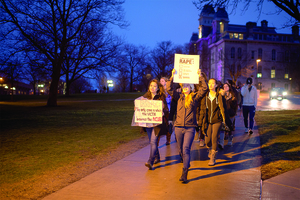 Students march on the Quad Wednesday night as part of Take Back the Night, a yearly event that seeks to raise awareness about domestic abuse and violence against women. The Advocacy Center coordinated the event, which featured a rally, march and speak-out. 
