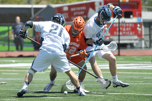 Syracuse midfielder Jojo Marasco fights for a ground ball with Villanova long-stick midfielder John LoCascio. While the Wildcats' defense limited Marasco, Orange attack Kevin Rice finished the game with five points to help pick up the slack. 