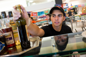 Sam Spector, an SU Food Services employee who receives work-study, fixes condiments at Sadler Dining Hall during his shift on Wednesday afternoon. Food Services is one of the highest-paid work-study opportunities on campus, paying a starting hourly rate of $9.80.