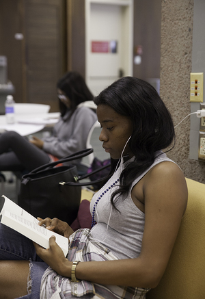 Ashley Thomas, a junior forensic psychology major, studies in Bird Library. Syracuse University Libraries is offering students a reserved study space for midterms week as the award for SU Libraries' social media contest, which ends Friday.