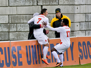 Alex Halis (7) runs to celebrate with an SU fan after scoring a goal in the first half of Syracuse's 2-0 win over Duke. The Orange advanced to the ACC tournament semifinals. 