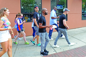 Musician Nick Jonas leaves Funk 'n Waffles followed by a small crowd.