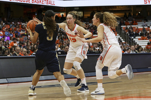 Syracuse, pictured pressuring Pittsburgh, has utilized man-to-man and zone defensive schemes this season. 