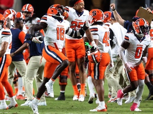 David Omopariola (pictured, No. 18) celebrates after recovering a fumble in the third quarter of SU's win over NC State. Defensive back Devin Grant forced the fumble on a sack of Wolfpack quarterback CJ Bailey.