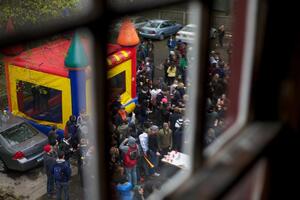 Students in the backyards of houses on the 500 block of Euclid Avenue celebrate MayFest with a bouncy castle.