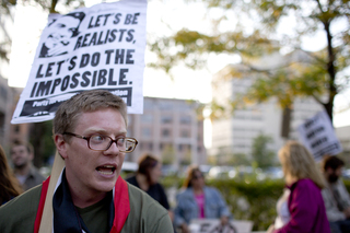 Derek Ford, a graduate student at SU and Occupy supporter, speaks before the the group walked to City Hall.