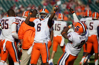 Syracuse defensive backs Ritchy Desir and Wayne Morgan celebrate on the Orange sideline.