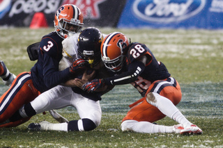 Syracuse safeties Durell Eskridge and Jeremi Wilkes make a tackle in the first half.