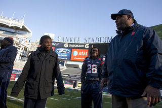 Secondary coach Donnie Henderson speaks with a child at Friday's 