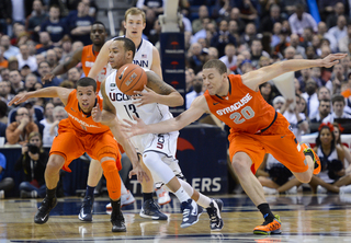 Syracuse guards Michael Carter-Williams and Brandon Triche chase down Connecticut point guard Shabazz Napier.