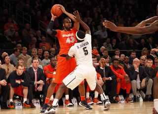 James Southerland dribbles the ball near the baseline, looking for an open teammate.