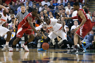 Keita fights for a loose ball between two N.C. State players. 