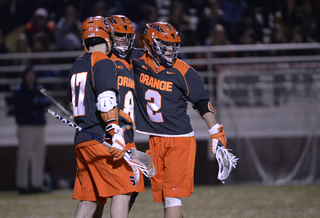 Kevin Rice (right) huddles with Lecky (middle) and Dylan Donahue. 