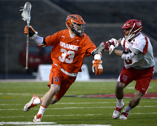 Midfielder Scott Loy heads for goal against a Cornell defender. 