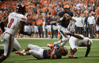 Quarterback Terrel Hunt scans his options as running back Prince-Tyson Gulley lies on the Carrier Dome turf.