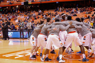 Syracuse huddles around forward B.J. Johnson as tipoff approaches.