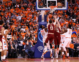 Christmas, Gbinije and Roberson surround Heckmann and BC forward John Cain Carney in a scramble for a loose ball in the paint.