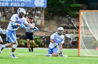 Tar Heels defender Bug Carper sticks his pole out to block a shot.