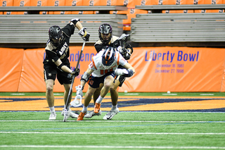 Brendan Curry is swarmed by two Army defenders. 