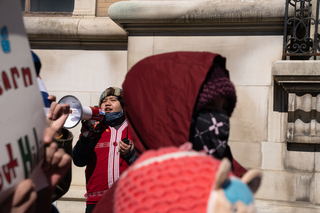 Demonstrators chant in Karen and English while marching through downtown Syracuse.